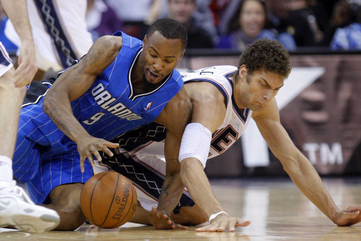 Nov 13, 2010; Newark, NJ, USA; Orlando Magic power forward Rashard Lewis (9) and New Jersey Nets center Brook Lopez (11) battle for loose ball at the Prudential Center. Mandatory Credit: Jim O'Connor